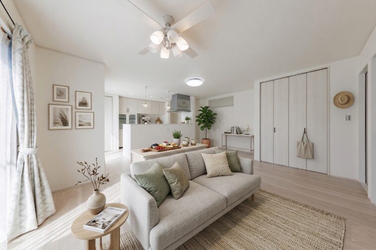 リビング全体を見渡せるオープンな対面キッチンを採用。背面のカップボードは白の木目調で統一し、清潔感と収納力を両立させました。お料理中もご家族とのコミュニケーションを大切にできる設計です。